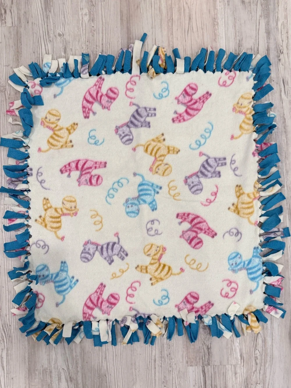 Unbranded Cream Fleece Throw with Multicolor Zebra Print and Blue Fringe